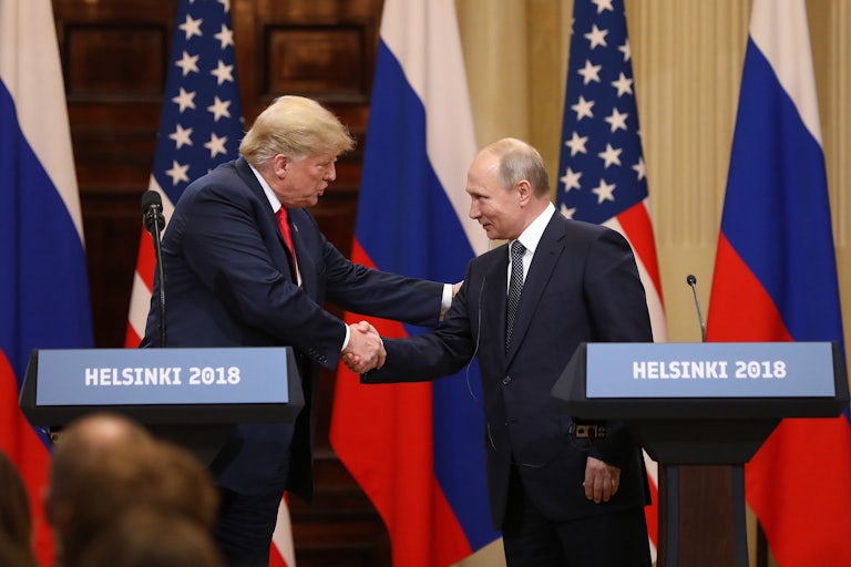Donald Trump shakes hands with Vladimir Putin during a meeting in Helsinki in 2018