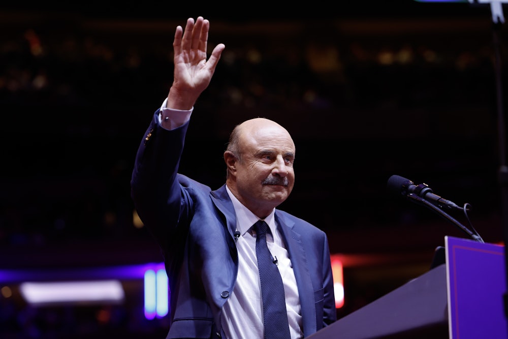 Dr. Phil raises his hand to wave.