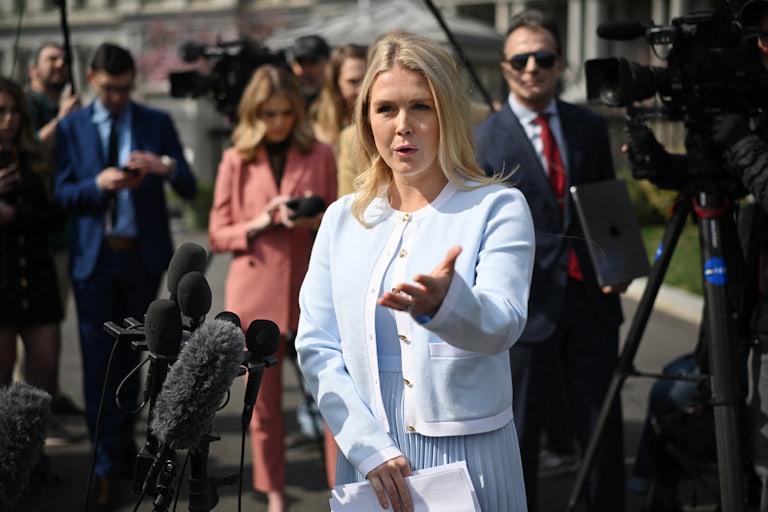 Press Secretary Karoline Leavitt gestures while speaking to reporters outside the White House