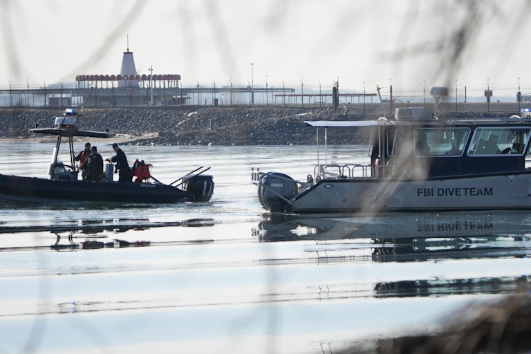 Emergency response teams search the river after a plane collided with a helicopter in Washington, D.C.