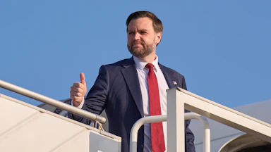 Vice President JD Vance gives a thumbs-up while standing at the top of the embarkment stairs of Air Force Two