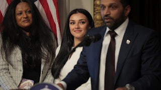 FBI Director Kash Patel speaks as his girlfriend Alexis Wilkins watches him.