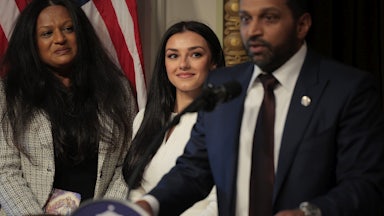 FBI Director Kash Patel speaks as his girlfriend Alexis Wilkins watches him.