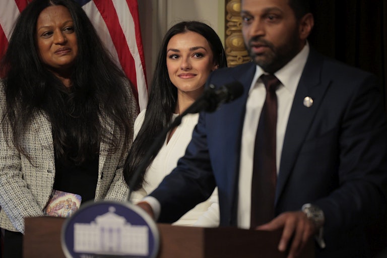 FBI Director Kash Patel speaks as his girlfriend Alexis Wilkins watches him.