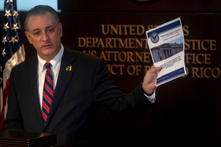 U.S. Attorney for the District of Puerto Rico, W Stephen Muldrow, speaks and holds up a piece of paper in his hand.