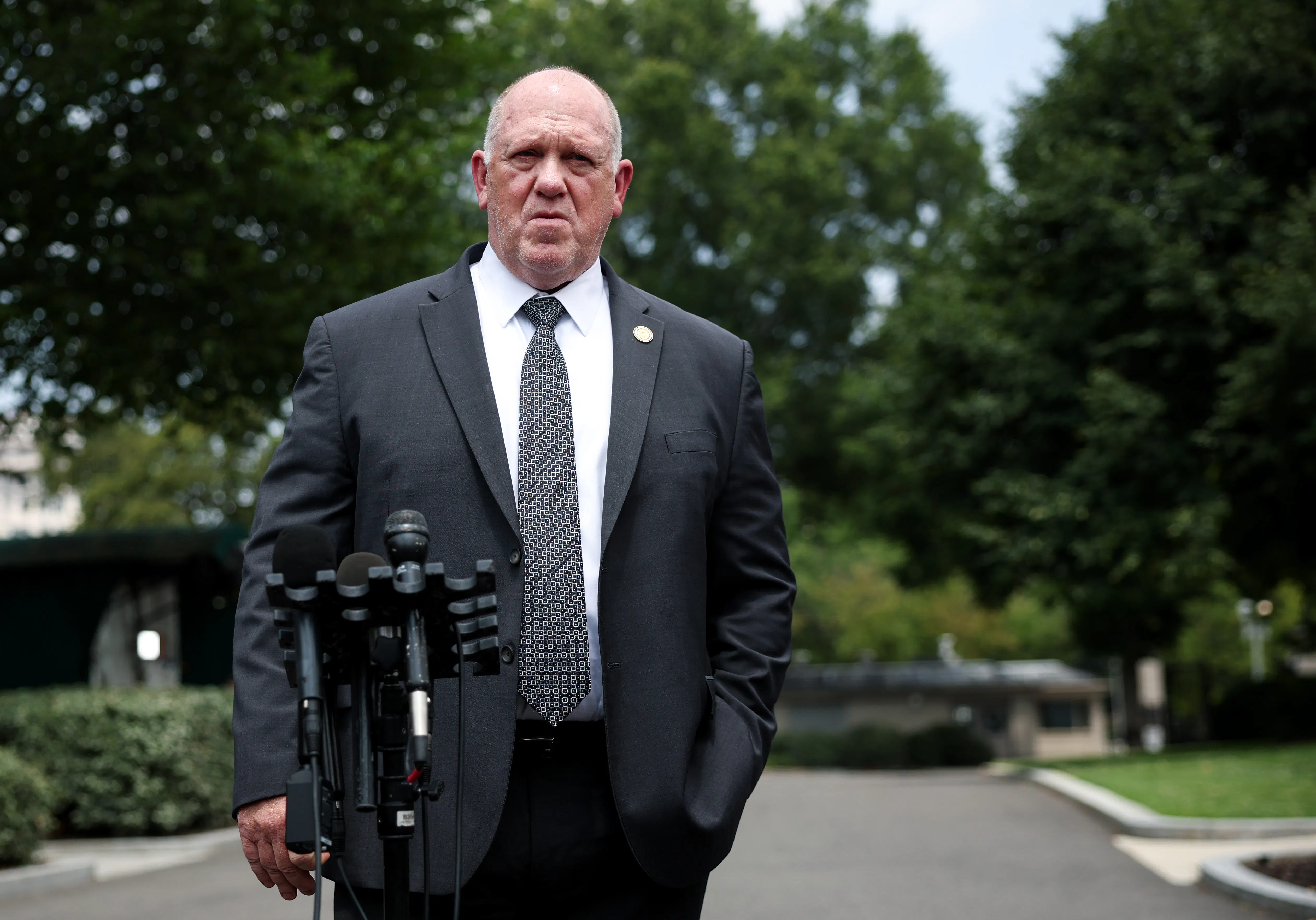 Trump border czar Tom Homan stands by a mic outside the White House.
