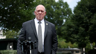 Trump border czar Tom Homan stands by a mic outside the White House.