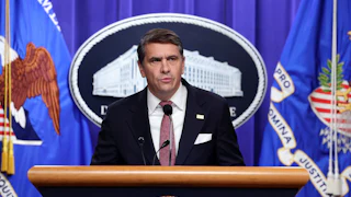 Acting Attorney General Todd Blanche speaks at a podium