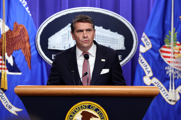 Acting Attorney General Todd Blanche speaks at a podium
