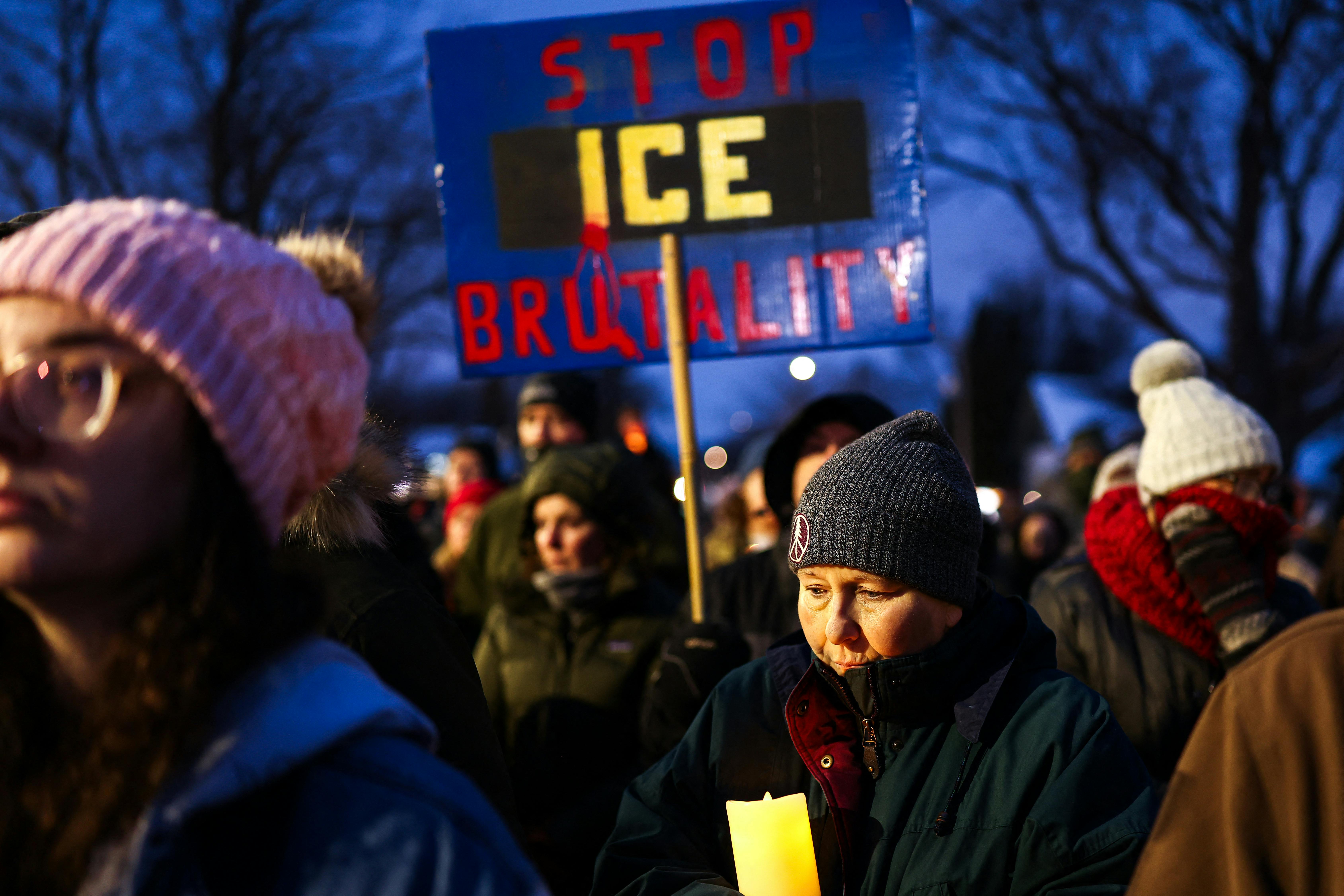 A person holds a sign that says, "Stop ICE brutality" during a vigil for Alex Pretti in Minneapolis, Minnesota