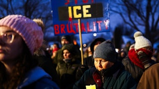 A person holds a sign that says, "Stop ICE brutality" during a vigil for Alex Pretti in Minneapolis, Minnesota