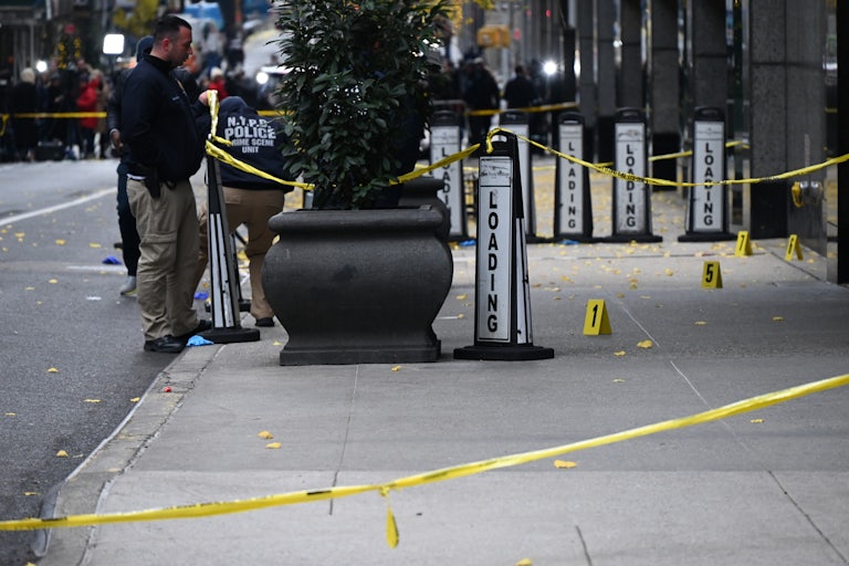 Police investigate outside the hotel where UnitedHealthcare CEO Brian Thompson was shot dead