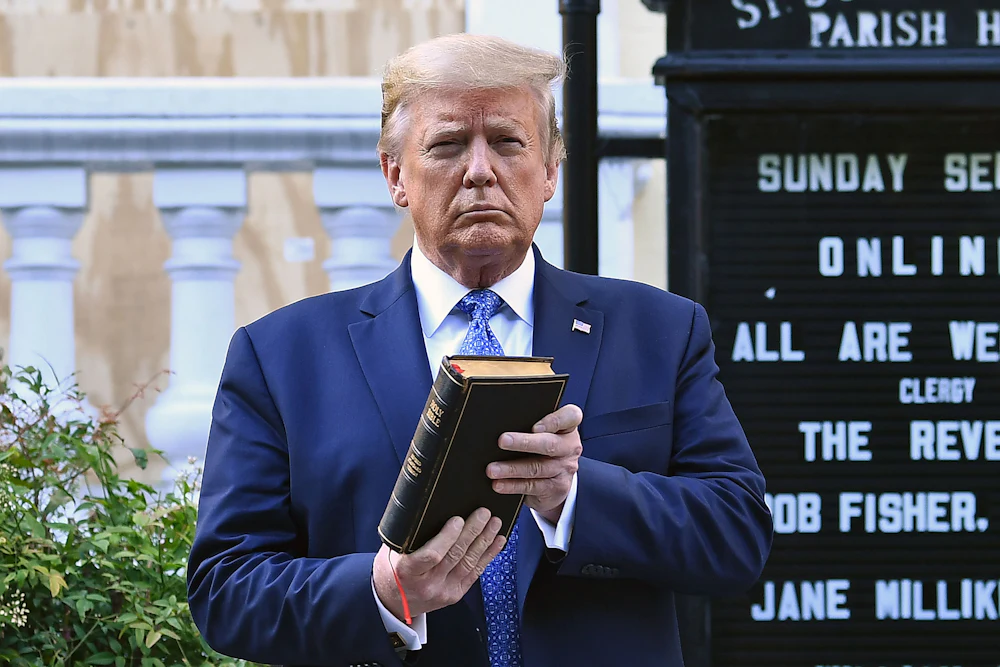 Donald Trump holds up a Bible outside of St John’s Episcopal church across Lafayette Park in Washington, D.C.