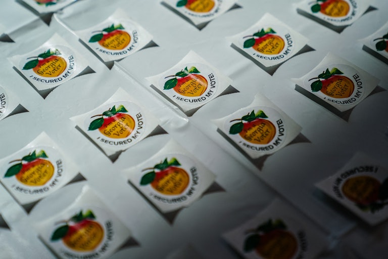 “I secured my vote” stickers on a table at a polling station in Georgia