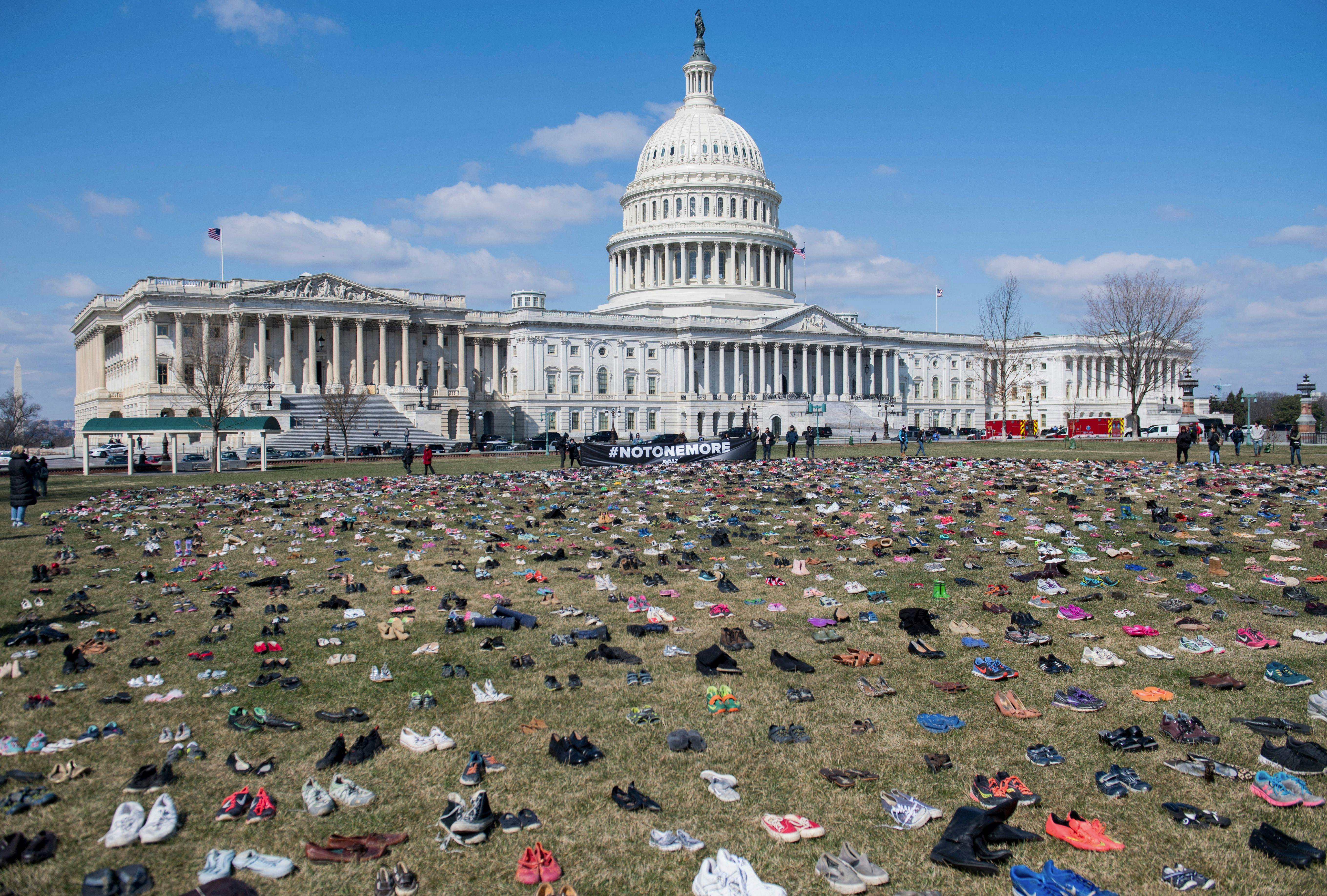 The lawn outside the US Capitol is covered with pairs of empty shoes to memorialize the children killed by gun violence since the Sandy Hook school shooting.