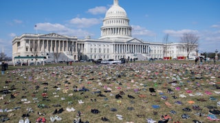 The lawn outside the US Capitol is covered with pairs of empty shoes to memorialize the children killed by gun violence since the Sandy Hook school shooting.