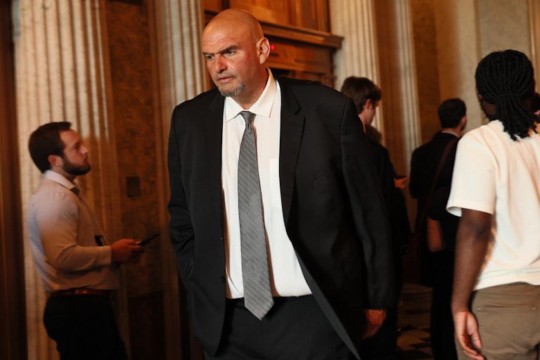 Senator John Fetterman walks out of a press conference.