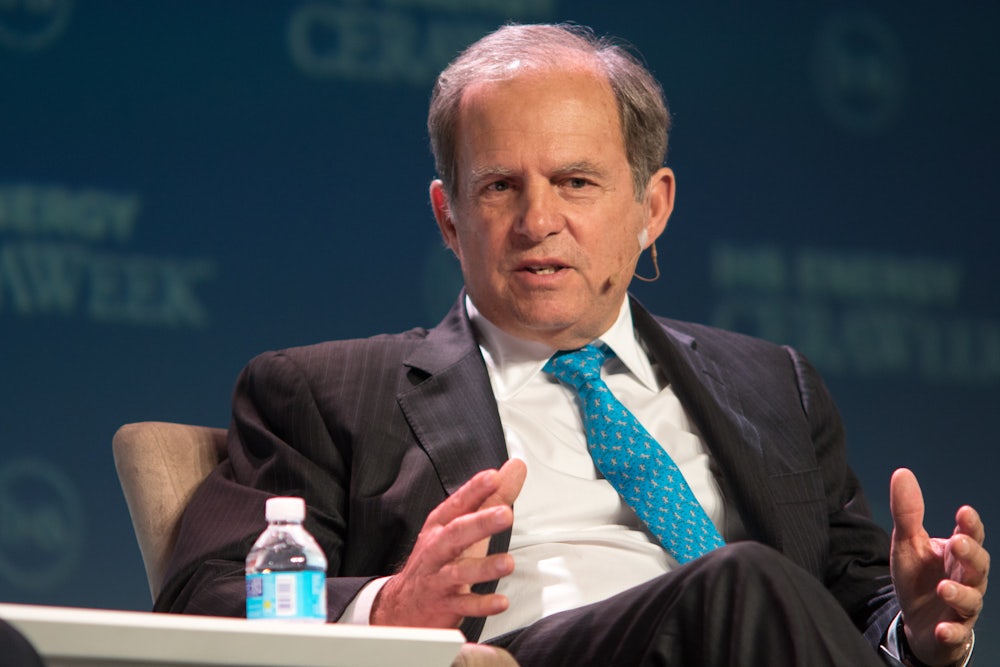 Scott Sheffield speaks and gesticulates while seated.