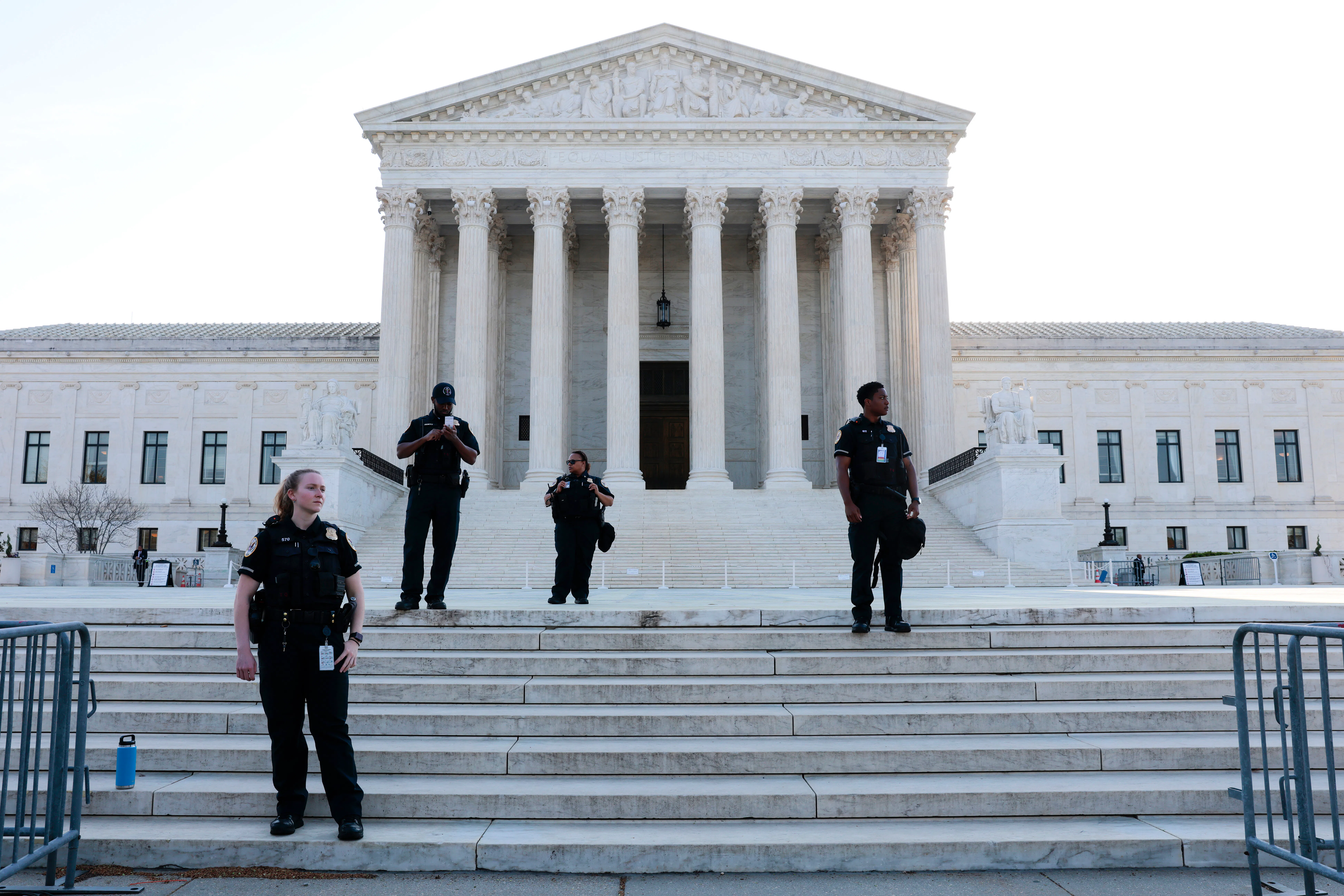 Police officers stand on steps of Supreme court