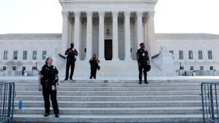 Police officers stand on steps of Supreme court