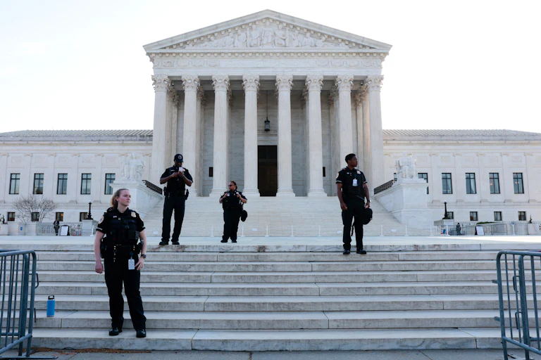 Police officers stand on steps of Supreme court