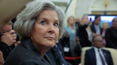 Susie Wiles glances over her shoulder while in a meeting.