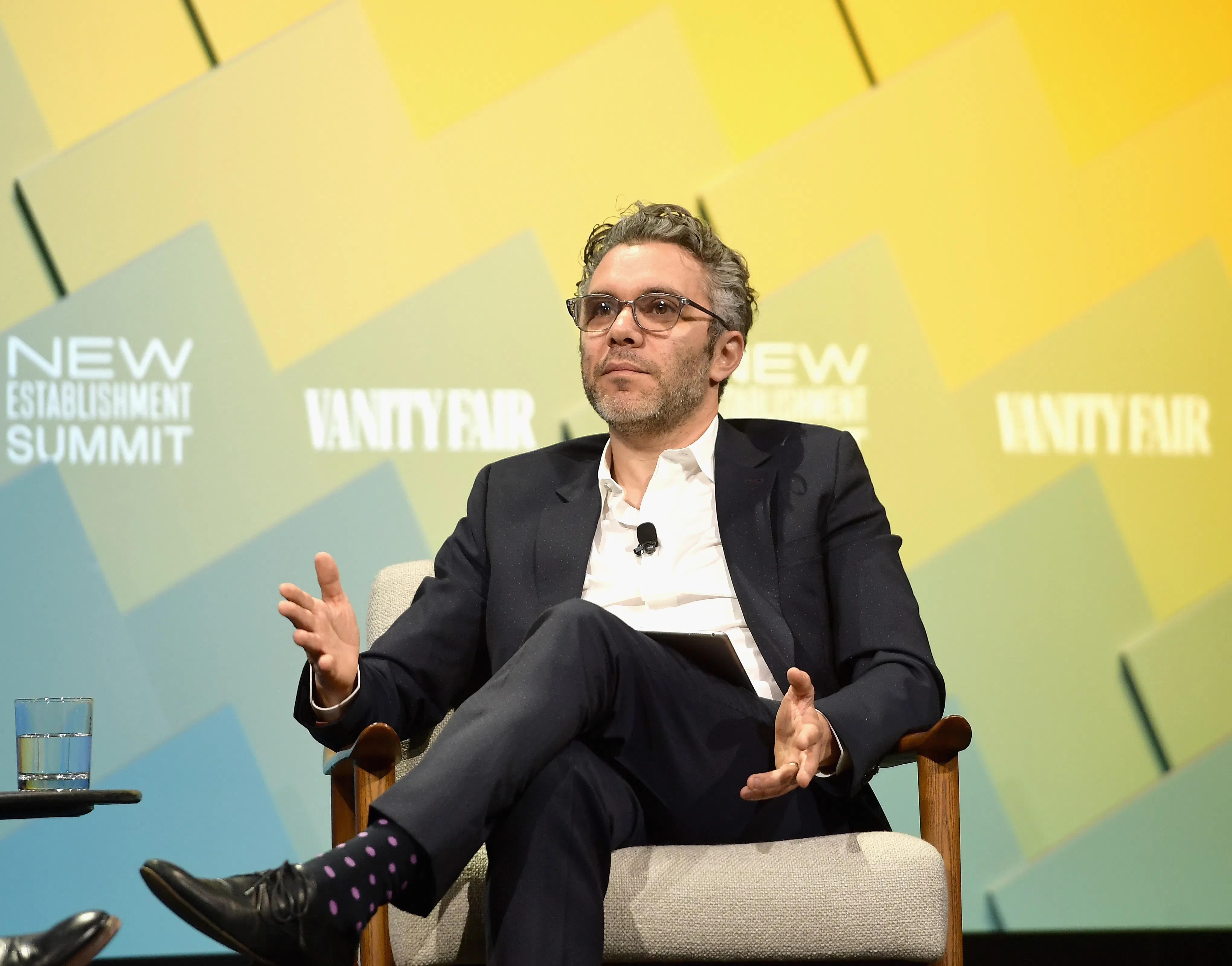 New 60 Minutes boss Nick Bilton gestures while sitting onstage during an event