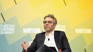 New 60 Minutes boss Nick Bilton gestures while sitting onstage during an event