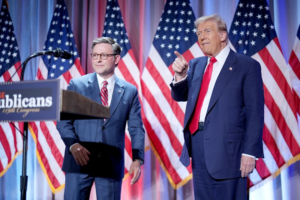 Speaker of the House Mike Johnson welcomes Donald Trump onstage at a House Republicans Conference meeting at the Hyatt Regency on Capitol Hill.
