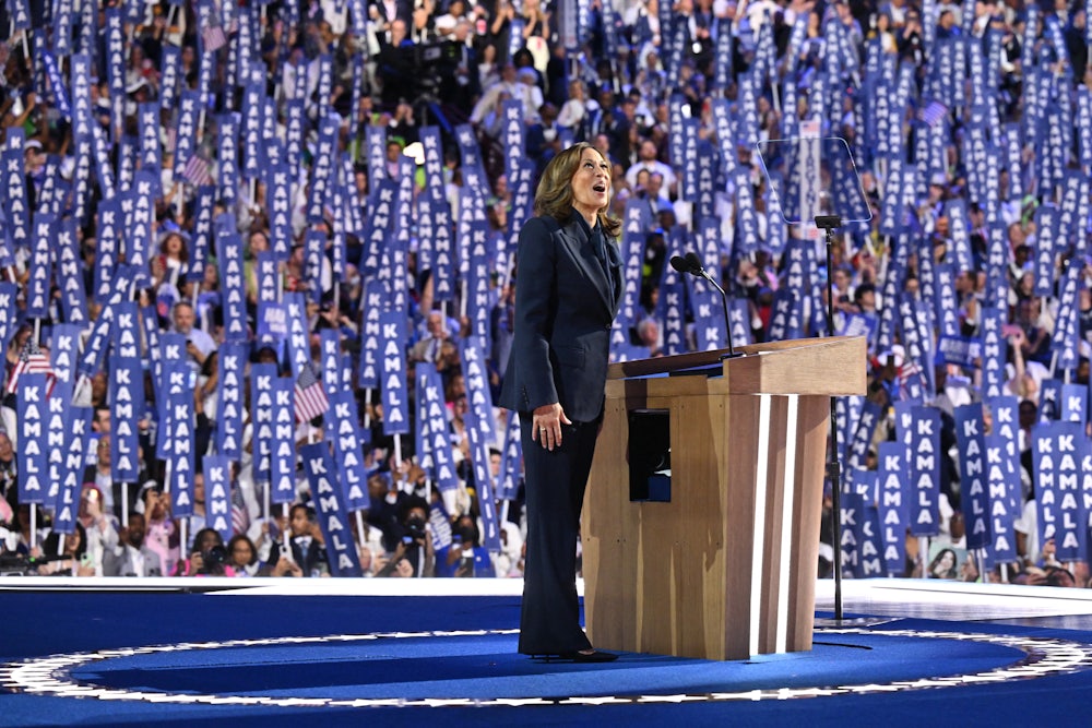 Kamala Harris reacts with an awestruck look as she arrives on stage speak on the fourth and final day of the Democratic National Convention amid a crowd of delegates holding signs reading "Kamala."