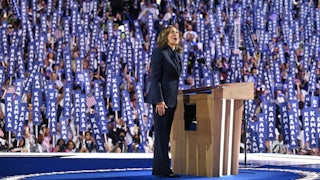 Kamala Harris reacts with an awestruck look as she arrives on stage speak on the fourth and final day of the Democratic National Convention amid a crowd of delegates holding signs reading "Kamala."