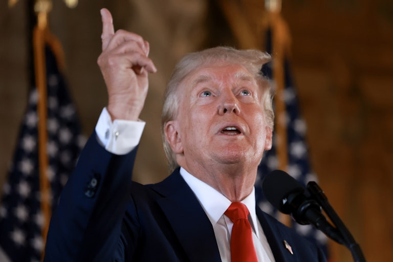 Donald Trump points upward during a press conference at Mar-a-Lago