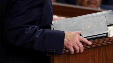 A giant blob of concealer (not the right shade) on Donald Trump's right hand.