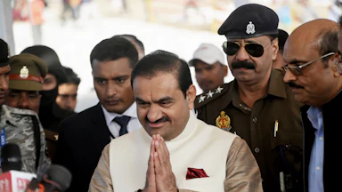 Gautam Adani, chairman of Adani Group, makes a prayer gesture with his hands