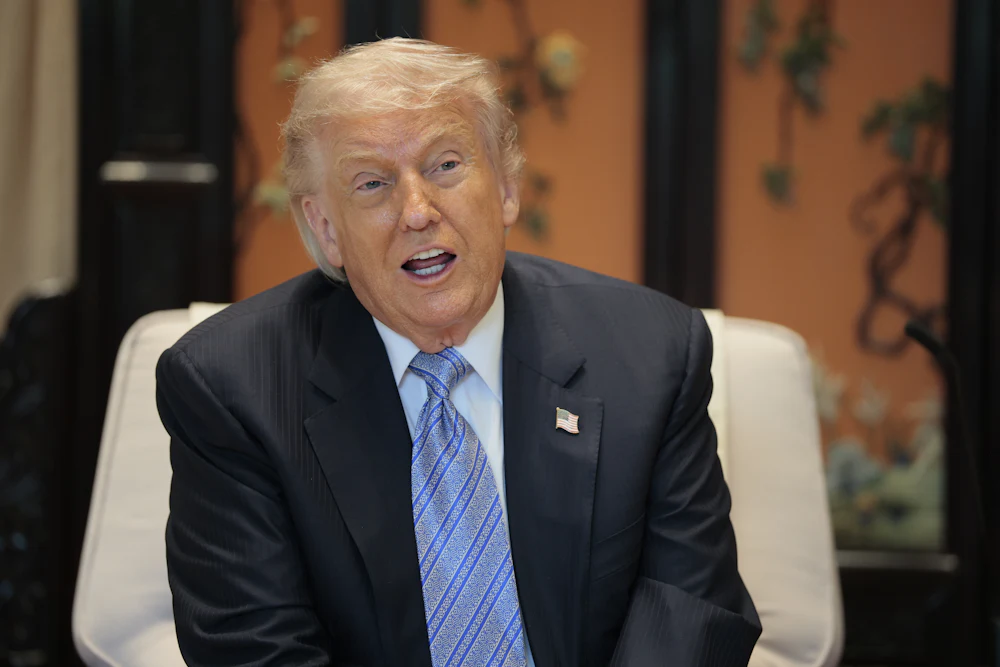 Donald Trump speaks while sitting