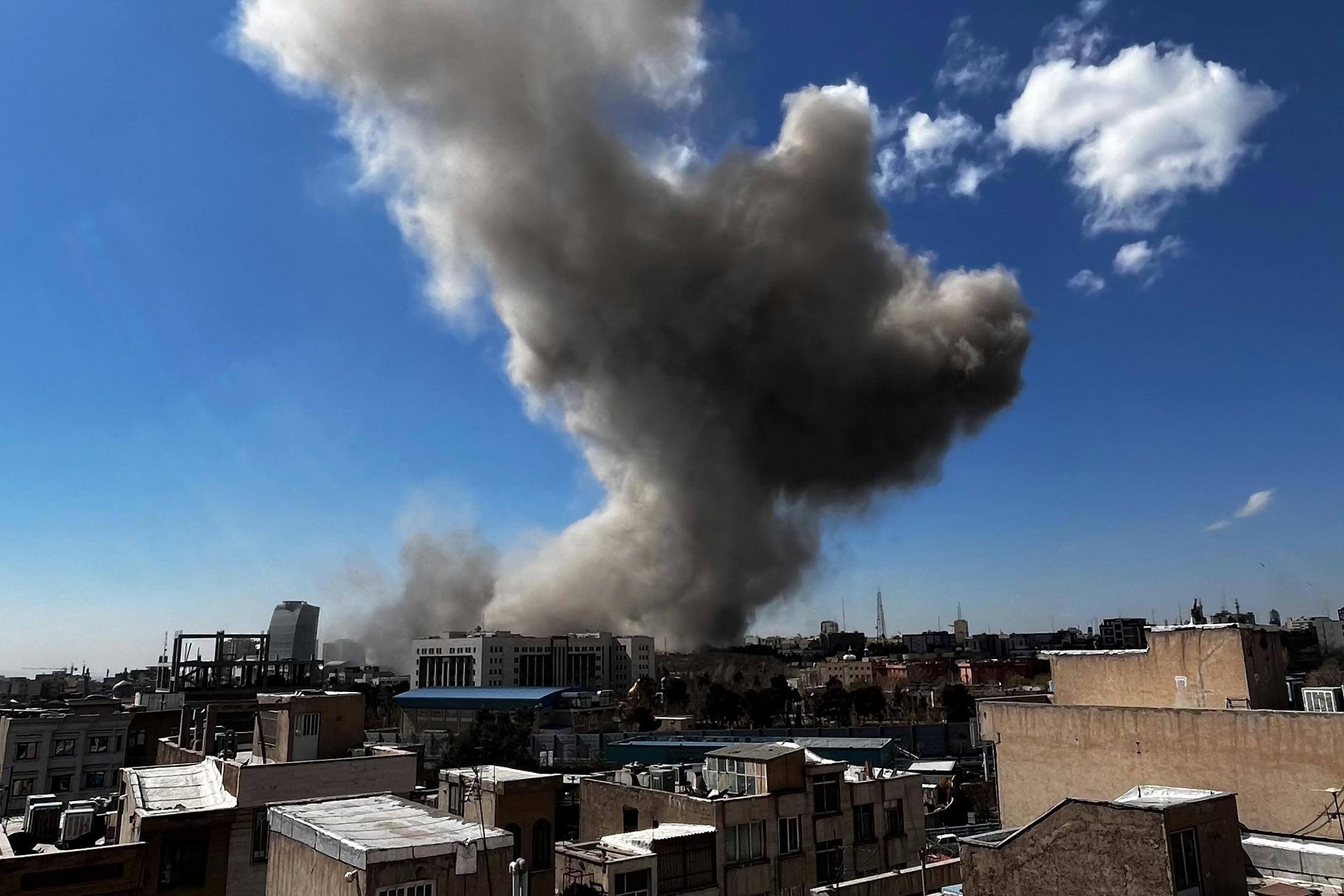 Plumes of smoke rise following explosions in Tehran