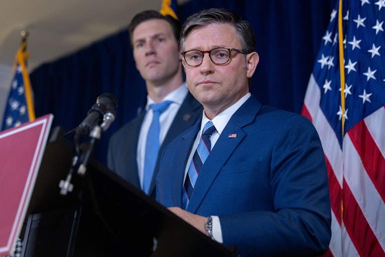 House Speaker Mike Johnson stands at a podium during a press conference