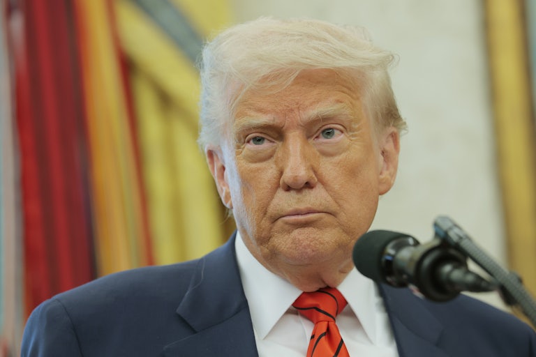 Donald Trump stands before a mic in the White House.