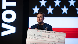 Elon Musk holds a massive $1,000,000 check.