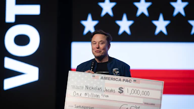 Elon Musk holds a massive $1,000,000 check.