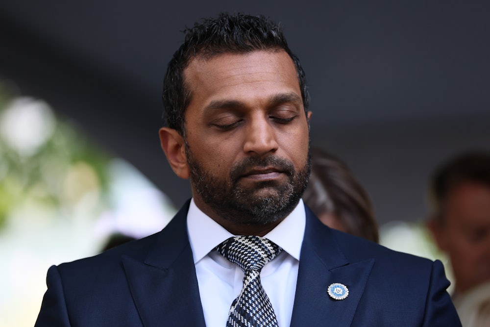 FBI Director Kash Patel stands with his eyes closed