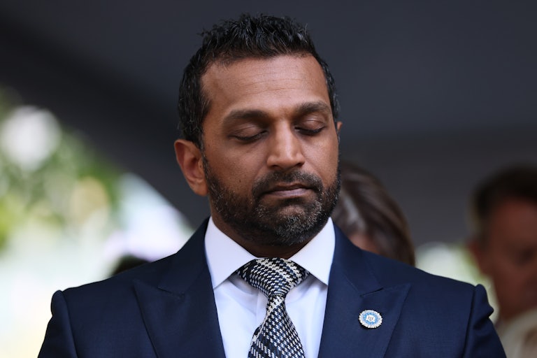 FBI Director Kash Patel stands with his eyes closed