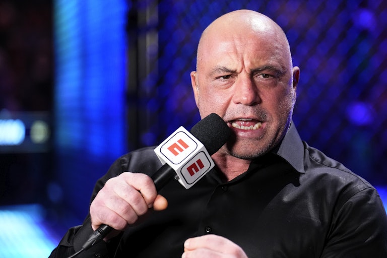 Joe Rogan speaks into a microphone during a UFC event