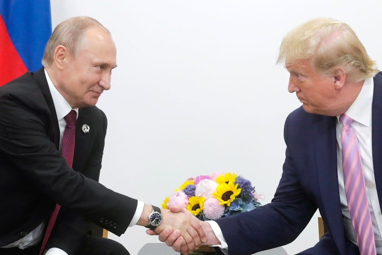 Vladimir Putin and Donald Trump shake hands