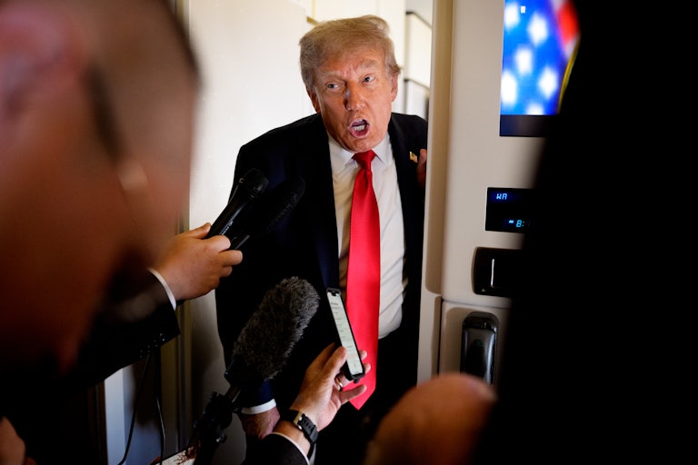 Donald Trump speaks to reporters on Air Force One
