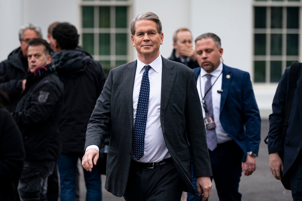 Scott Bessent walks toward the camera with others walking behind him