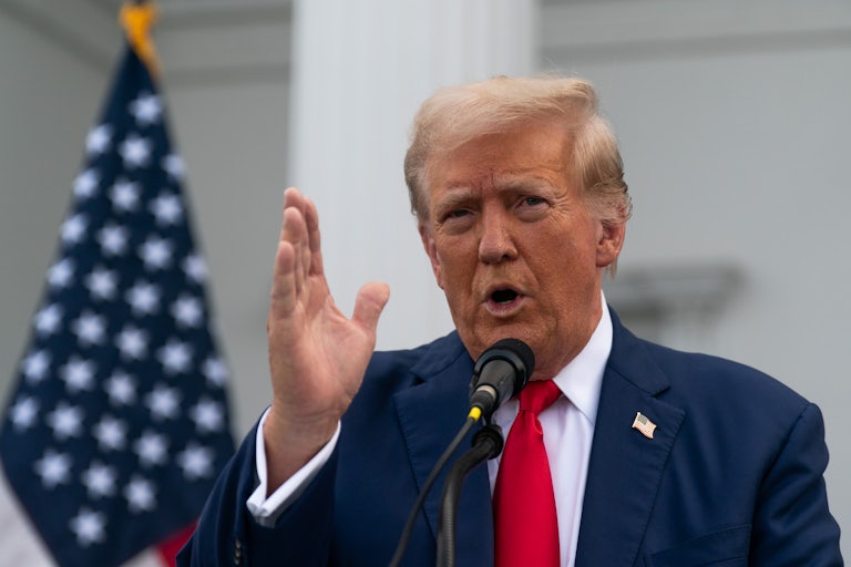 Donald Trump gestures while speaking at a press conference
