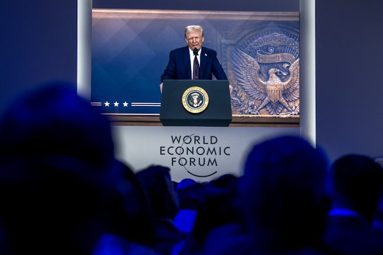 Donald Trump speaks at a podium during a virtual appearance at the Davos World Economic Forum