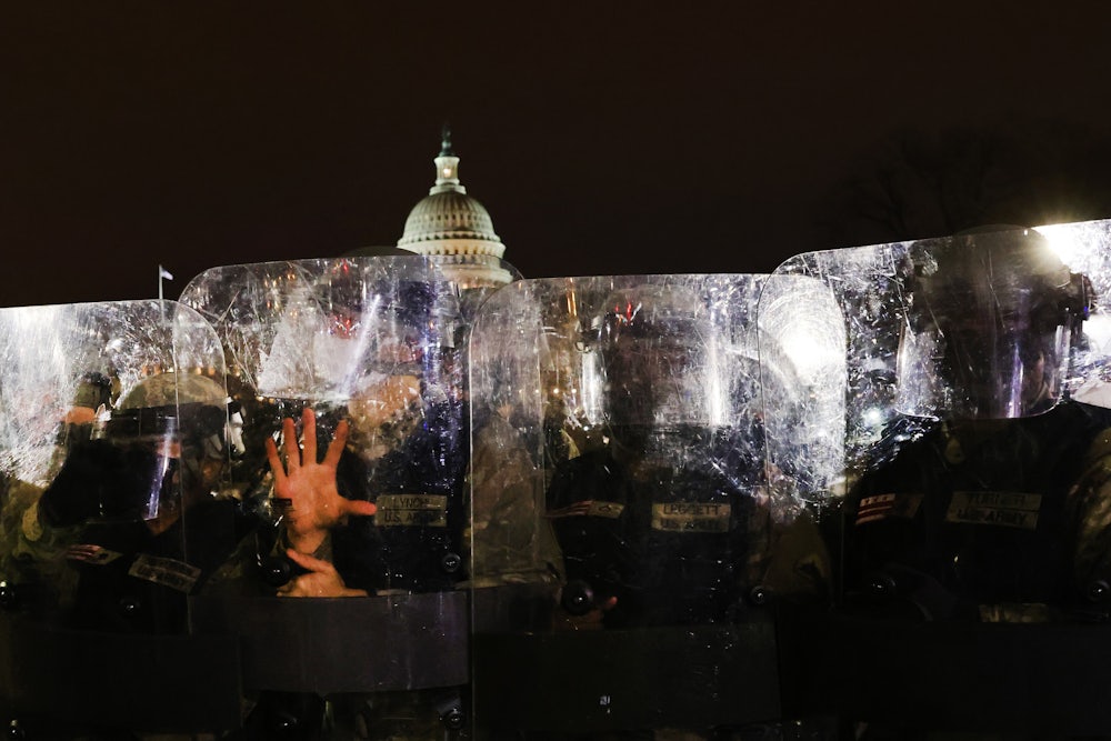 Members of the National Guard and the Washington D.C. police keep a small group of demonstrators away from the U.S. Capitol after a larger group stormed the building.