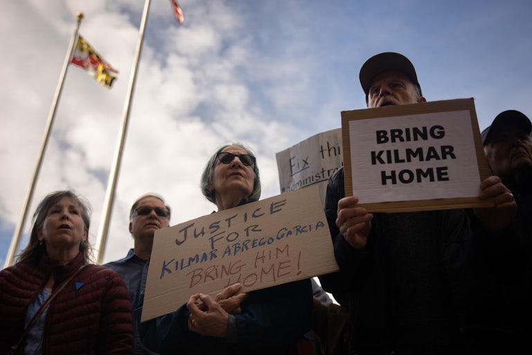 Protesters hold up signs calling for the return of Kilmar Abrego García outside a courthouse in Maryland